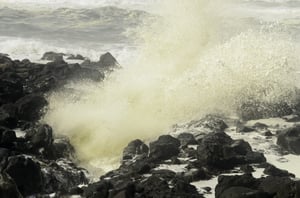 Natural metaphor of conflict Ocean wave exploding against volcanic rocks along Pacific coast of Oregon