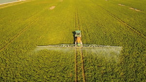 bigstock-Aerial-View-Tractor-Spraying-T-225500425