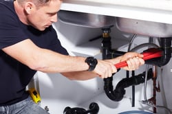 bigstock-Plumber-man-with-tools-in-the--84631145